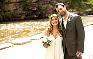 woman in white wedding gown holding bouquet of flowers