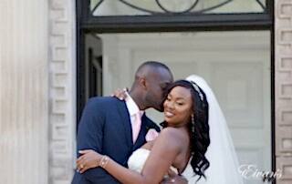 Kissing his new wife's cheek making her smile with only true love and excitement.