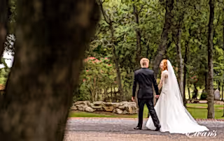The couple strolls down a beautiful nature pathway celebrating their new found love.