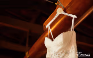 The hanger holding the bride's gown has her soon-to-be new last name.