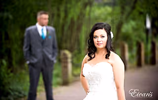 The bride looks absolutely effortless while standing in front of her groom.