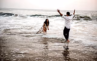 This beautiful couple is captured in a candid moment by this Eivan photographer as they play in the ocean just enjoying one another's company. You can see just how much they want to be together.