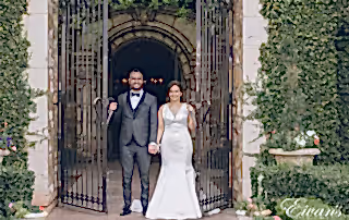 man in black suit and woman in white wedding dress standing in front of brown wooden