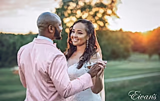 man in white dress shirt holding woman in gray dress