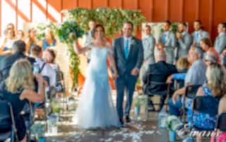 a couple walking down the aisle after they say "i do"
