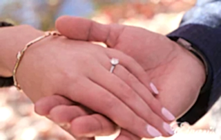 engaged man holding his fiancees hand