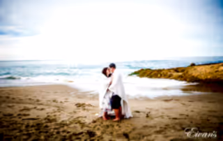 woman in white dress standing on beach during daytime